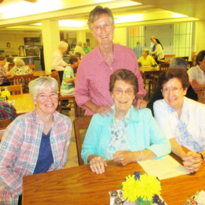 Gathering in the dining room are, from left, Sisters Nancy Liddy, Mary Ellen Backes (standing), Elaine Burke and Mary Henning.