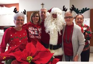 Associates, from left, Betty Boren, Risë Karr, Mike Sullivan, Santa Claus, along with Vicki Kloss and Debbie Dugger, activities coordinator at Maple Mount, stop for a photo. Once again, Associate John Wood never seemed to be around when Santa was there.