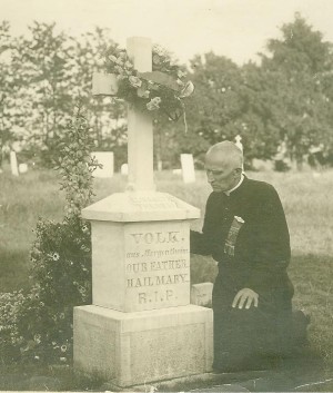 Father Volk prays by the grave of his mother, Elisabeth Volk, who is buried in the St. Alphonsus Cemetery next to Mount Saint Joseph.