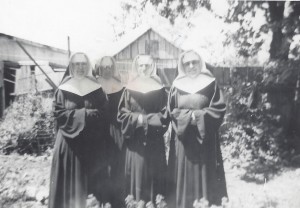 Sisters Mary Otho Abell, Mary Beatrice Donohue, Mary Louise Riney, Mary Victor Rogers in the backyard at old St. Edward.